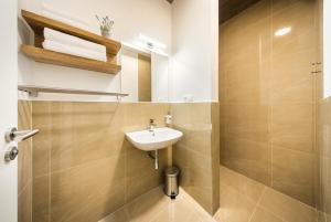 a bathroom with a sink and a shower at Apartmány Panelka Costa Plana Lipno in Černá v Pošumaví