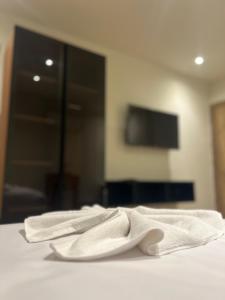two white towels sitting on top of a bed at King's Gate Royal View INN in Cairo +22 photos