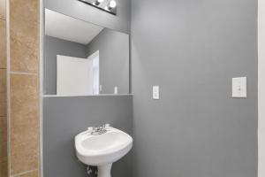 a bathroom with a sink and a toilet and a mirror at OYO Oasis Motel Las Vegas I-15 in Las Vegas