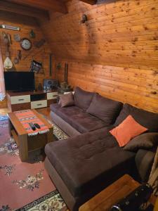 a living room with a couch and a table at Bungalows Dormire in Žabljak