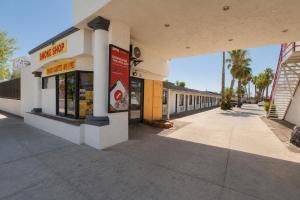 a building with a sign on the side of it at OYO Oasis Motel Las Vegas I-15 in Las Vegas +57 photos