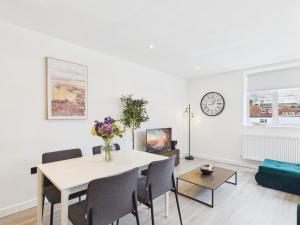 a white living room with a table and chairs at Luxury Two Bed | Sleeps 6 | 5 beds in Brent Station