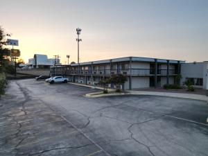 an empty parking lot in front of a building at Texas Inn & Suites in Denton
