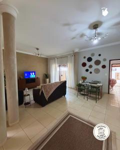 a living room with a couch and a table at Pousada Bem Estar Frutal in Frutal