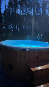 a large blue tub with trees in the background at Roztoczańska Stodoła in Majdan Sopocki