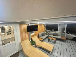a living room with a couch and chairs and a tv at Mobile Home David-Camp Soline in Biograd na Moru