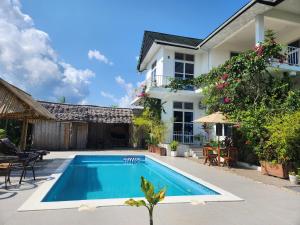 an image of a villa with a swimming pool at Maneri Villa and Apartments in Zanzibar City