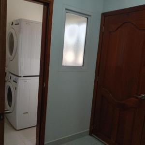 a kitchen with a washing machine and a window at Casa Venus in El Gigante