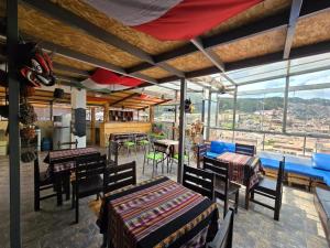 a dining room with tables and chairs and windows at Darios Hotel in Cusco