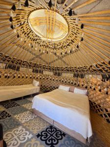 a bedroom with a bed and a large mirror at Yurt Camp by Fly Service in Song-Kul