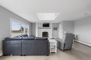 a living room with a couch and a chair at Gulls Nest in Gloucester