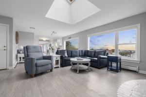a living room with a couch and chairs and a table at Gulls Nest in Gloucester