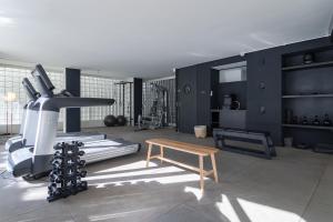 a room with a gym with a treadmill and a bench at Tabas - Renata Edifício - Vila Buarque in São Paulo