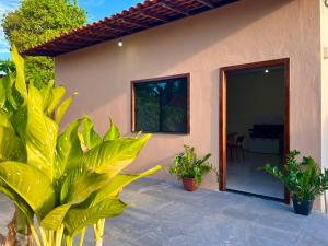 a house with plants in front of it at Vila da Andrea in Barreirinhas