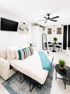a white bedroom with a large bed and a living room at The Arlington Hideaway in Jacksonville +22 photos