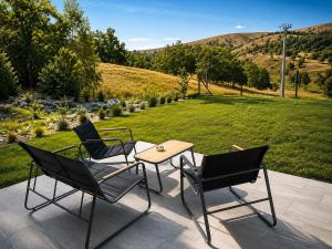 two chairs and a table on a patio at Stress Away in Zlatibor