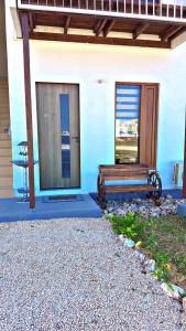 a bench sitting in front of a blue building at Two Bedroom Moyoni Apartment in Mchamba Wima