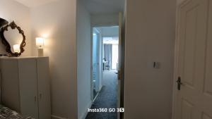 a hallway with a mirror and a door to a room at Abysplace SM in Kenton
