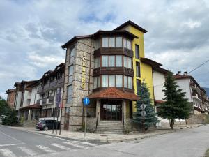 a tall building on the corner of a street at Hotel Iceberg Bansko in Bansko +42 photos