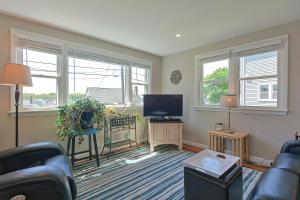 a living room with a couch and a tv at Ryal Side Hideaway Cove in Beverly