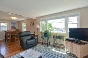 a living room with a chair and a television at Ryal Side Hideaway Cove in Beverly