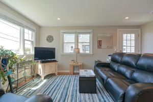 a living room with a couch and a flat screen tv at Ryal Side Hideaway Cove in Beverly