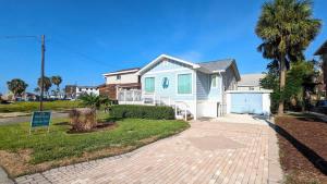a white and blue house with a driveway at 213 Ohio in Fort Myers Beach