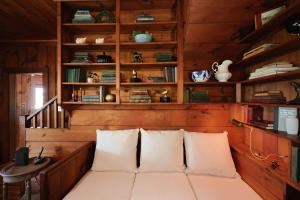 a room with wooden walls and shelves with white pillows at Tidebend in Gloucester