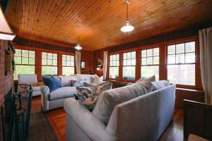 a living room with two couches and windows at Tidebend in Gloucester