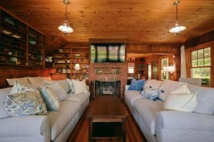 a living room with two couches and a fireplace at Tidebend in Gloucester +58 photos