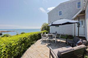 a patio with a table and an umbrella at The Rockporter in Rockport