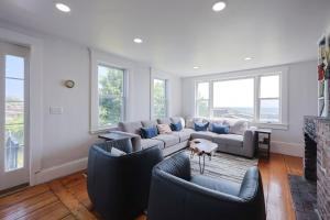 a living room with couches and a fireplace at The Rockporter in Rockport