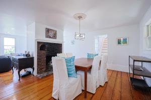 a dining room with a table and chairs and a fireplace at The Rockporter in Rockport +45 photos