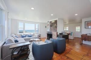 a living room with a couch and a fireplace at The Rockporter in Rockport