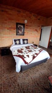 a bedroom with a large bed in a brick wall at Alojamiento temático Rancho Texas in La Mesa +4 photos