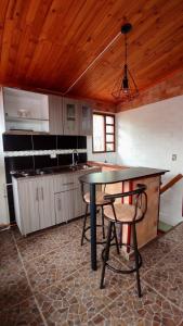 a kitchen with a table and chairs in a room at Alojamiento temático Rancho Texas in La Mesa