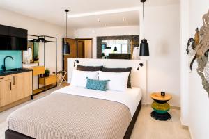 a bedroom with a large bed and a kitchen at Ermou w Jacuzzi Acropolis View Monastiraki in Athens