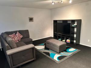 a living room with a couch and a flat screen tv at Spacious Duplex in Camrose