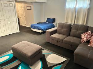 a living room with a couch and a bed at Spacious Duplex in Camrose