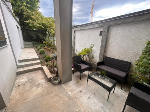 a balcony with two chairs and a bench on a building at Apartman 4N with free parking in Belgrade