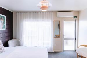 a bedroom with a white bed and a window at The Mayfair in Hastings +42 photos
