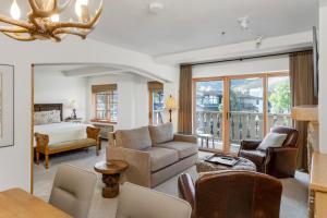 a living room with a couch and a bed at Christiania Condominiums- CoralTree Residence Collection in Vail +27 photos