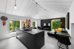 a kitchen with a black island in a living room at The Hayloft in Strabane +30 photos