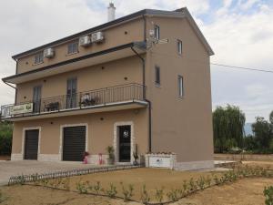 a large building with a balcony on top of it at Esmeralda B&B in Casa San Biagio