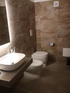 a bathroom with a white sink and a toilet at Esmeralda B&B in Casa San Biagio +31 photos