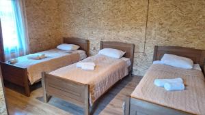 a room with three beds with towels on them at Sarag in Ushguli