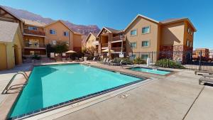 a swimming pool at a apartment complex with buildings at Red Cliff Condos #3i in Moab