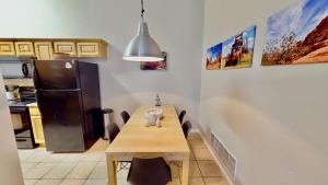 a kitchen with a wooden table and a refrigerator at Red Cliff Condos #3i in Moab