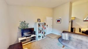 a living room with a couch and a flat screen tv at Red Cliff Condos #3i in Moab