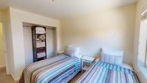 a bedroom with two beds and a closet at Leisure Space #327 in Moab